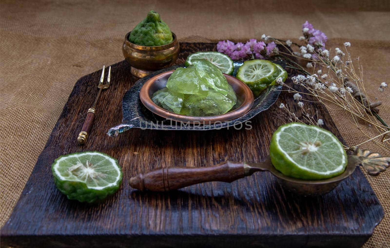 Traditional Thai dessert call candied kaffir lime on wooden background. Summer time, Selective Focus.
