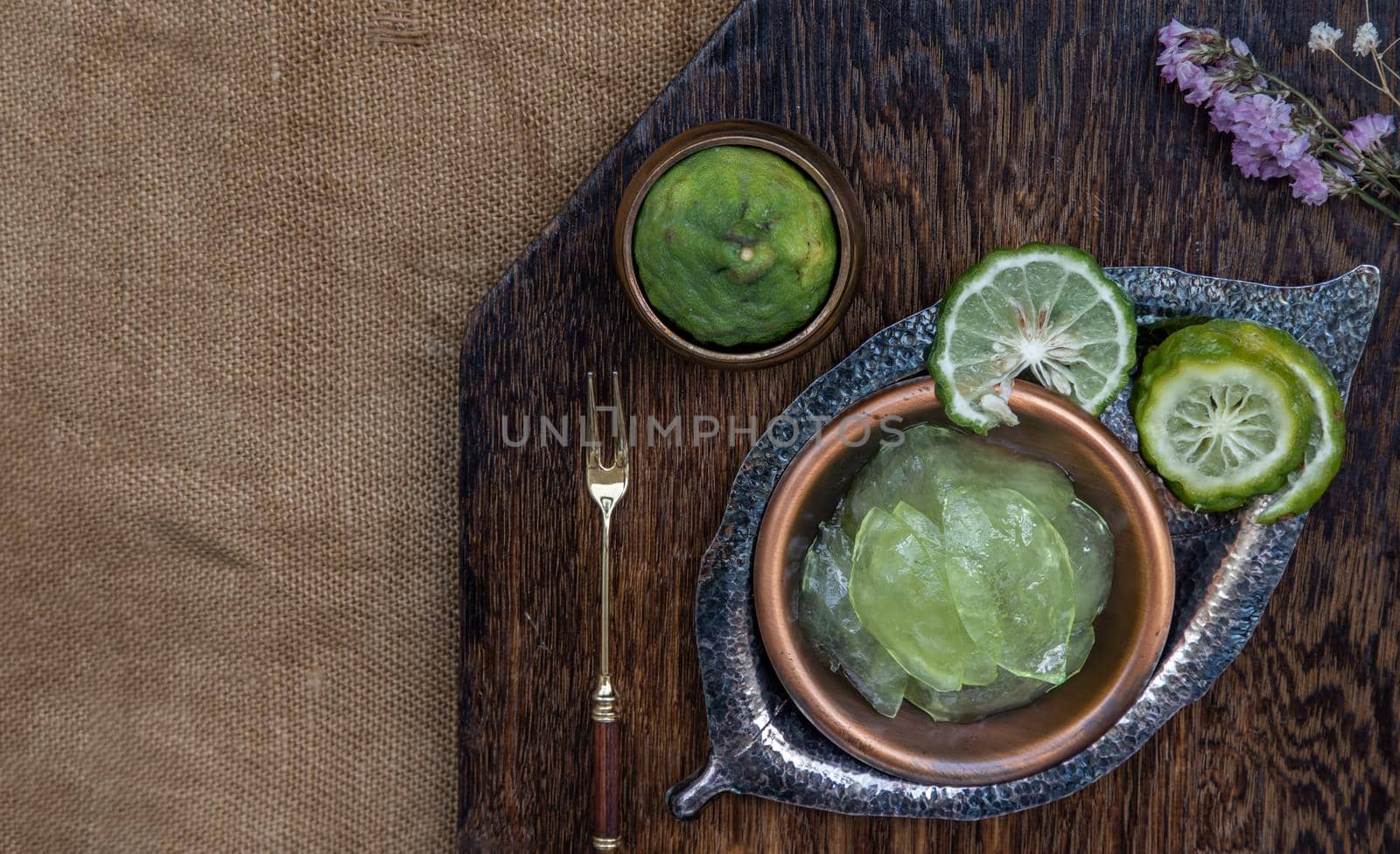 Traditional Thai dessert call candied kaffir lime on wooden background. Summer time, Selective Focus.