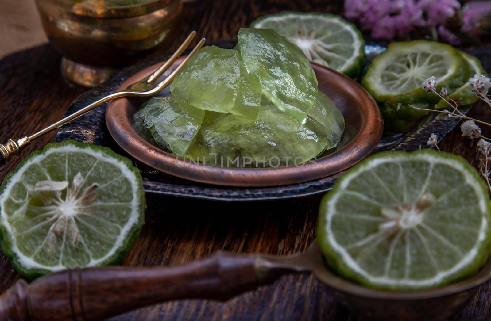 Traditional Thai dessert call candied kaffir lime on wooden background. Summer time, Selective Focus.