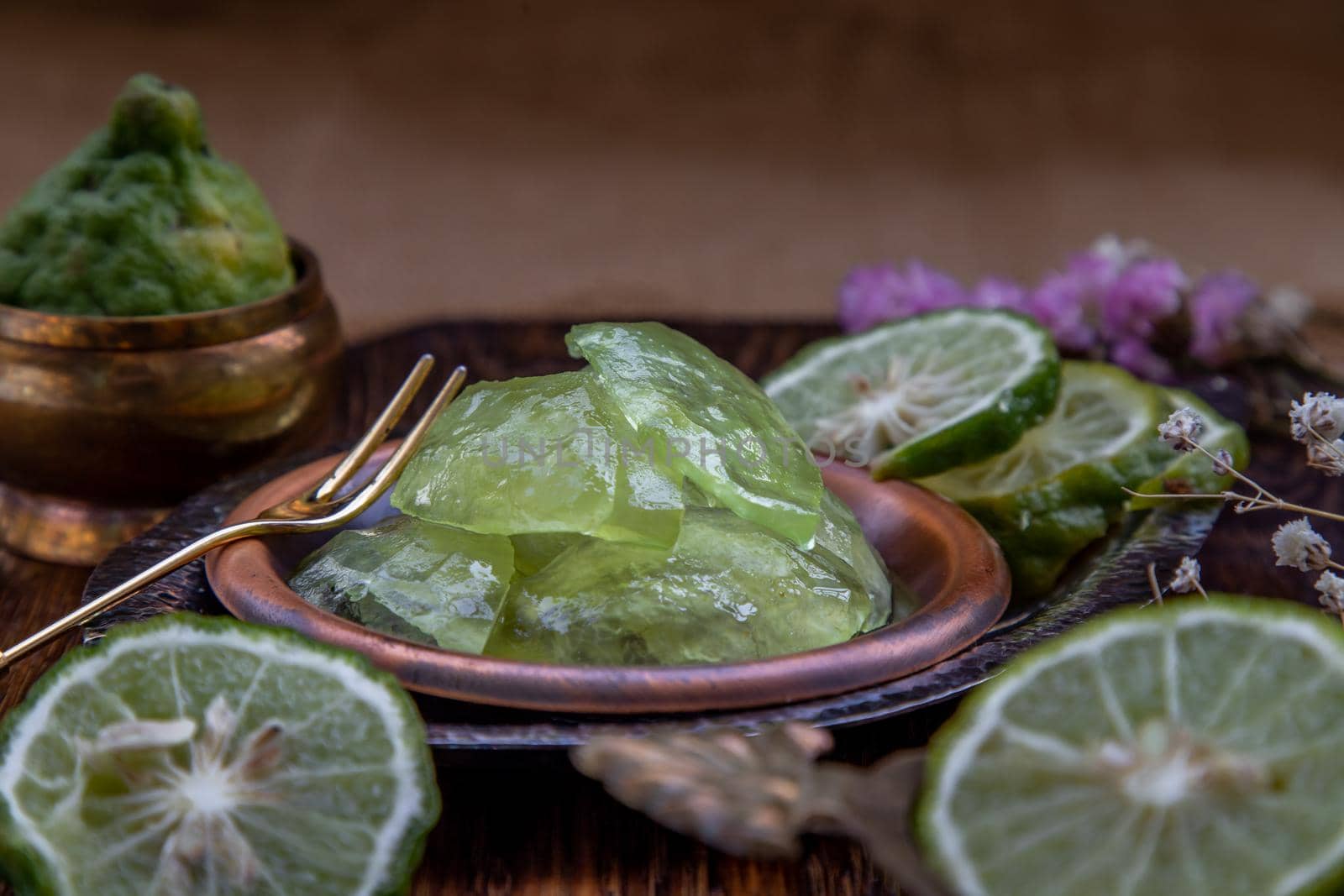 Traditional Thai dessert call candied kaffir lime on wooden background. Summer time, Selective Focus.