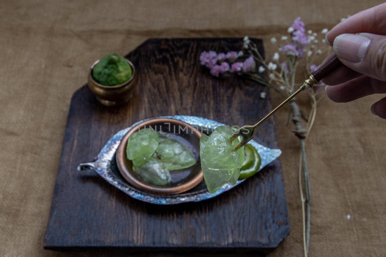 Traditional Thai dessert call candied kaffir lime on wooden background. Summer time, Selective Focus.