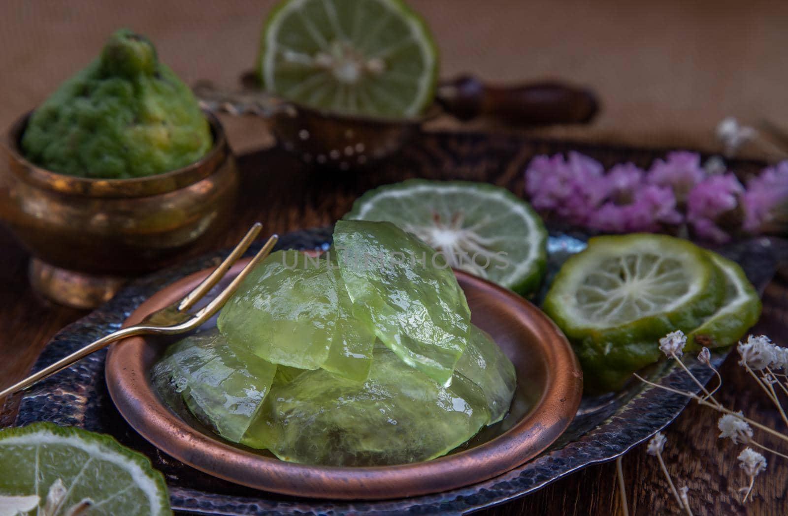 Traditional Thai dessert call candied kaffir lime on wooden background. Summer time, Selective Focus.