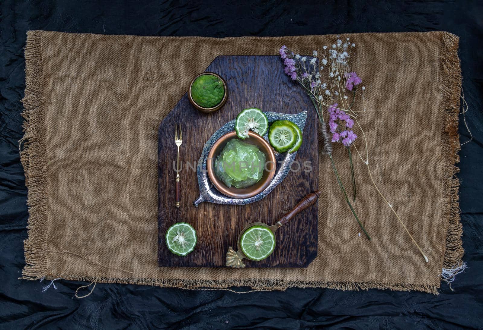 Traditional Thai dessert call candied kaffir lime on wooden background. Summer time, Selective Focus.