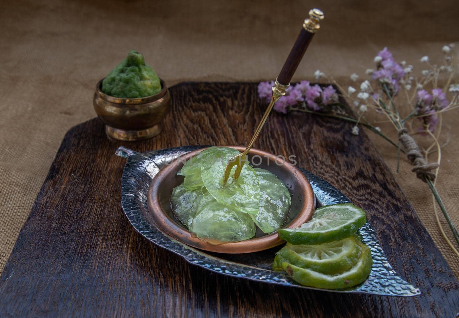Traditional Thai dessert call candied kaffir lime on wooden background. Summer time, Selective Focus.