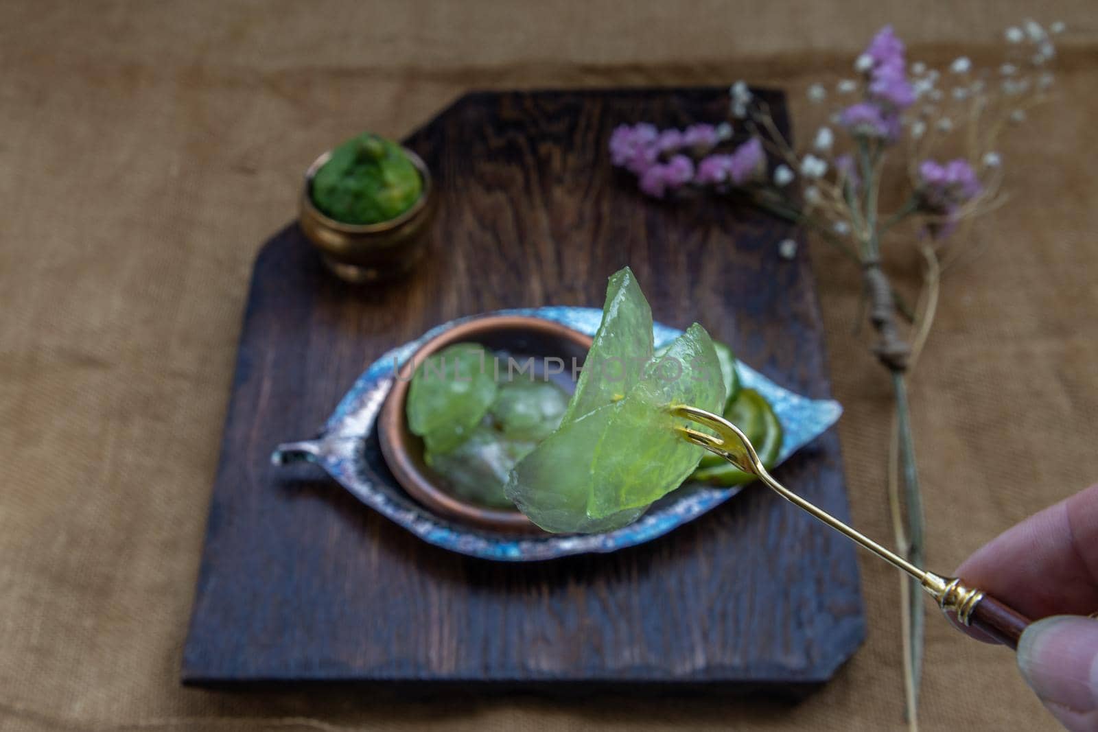 Traditional Thai dessert call candied kaffir lime on wooden background. Summer time, Selective Focus.