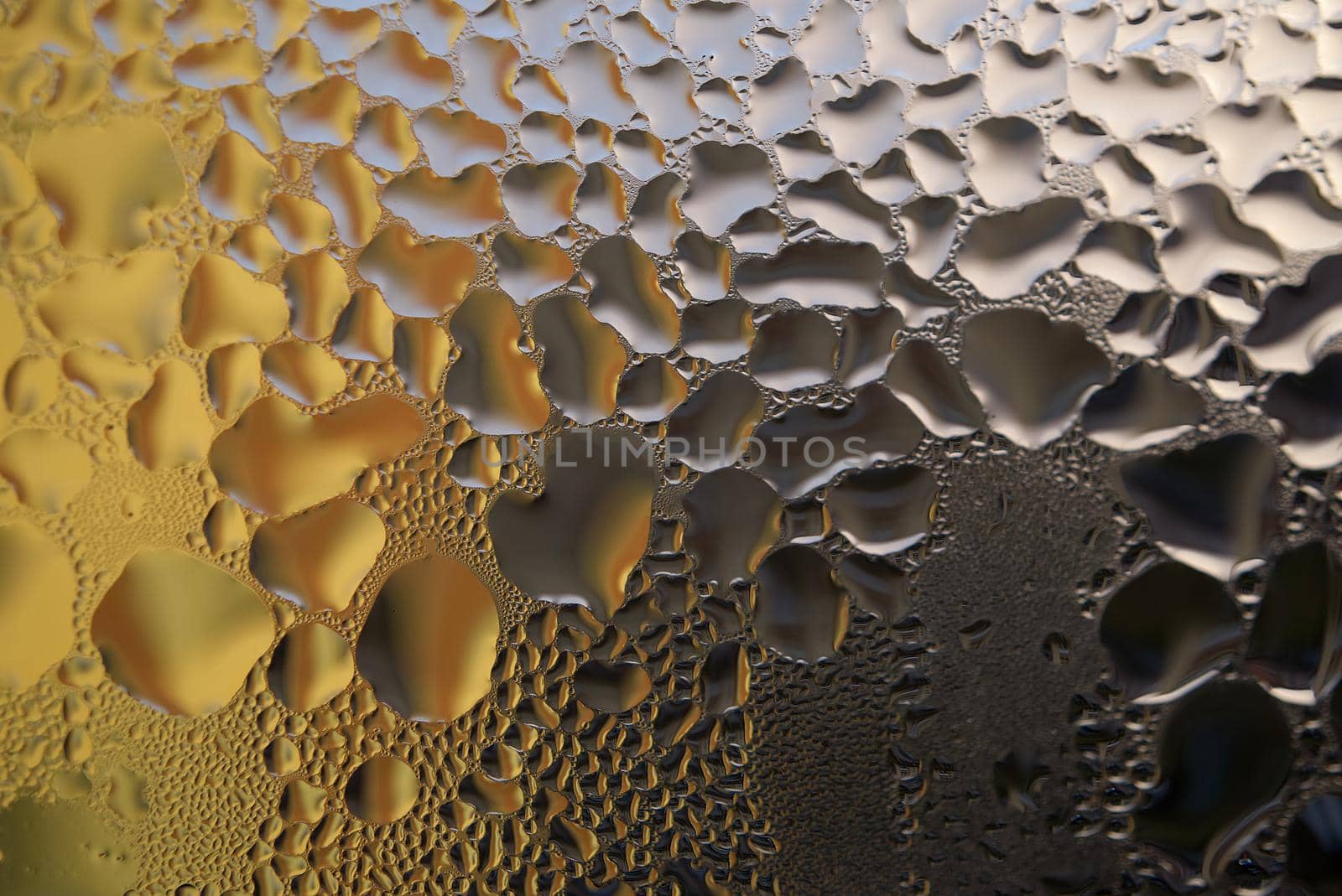 Water droplets or condensation on the outside of a cold windows in a close up full frame background texture