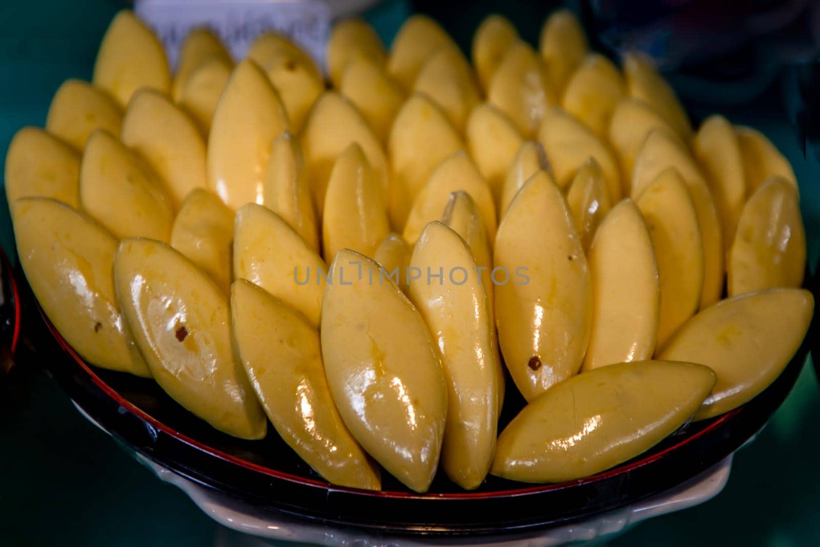 Traditional Thai Dessert Call Nah nuan make by egg yolk and sugar serving in a wooden background.