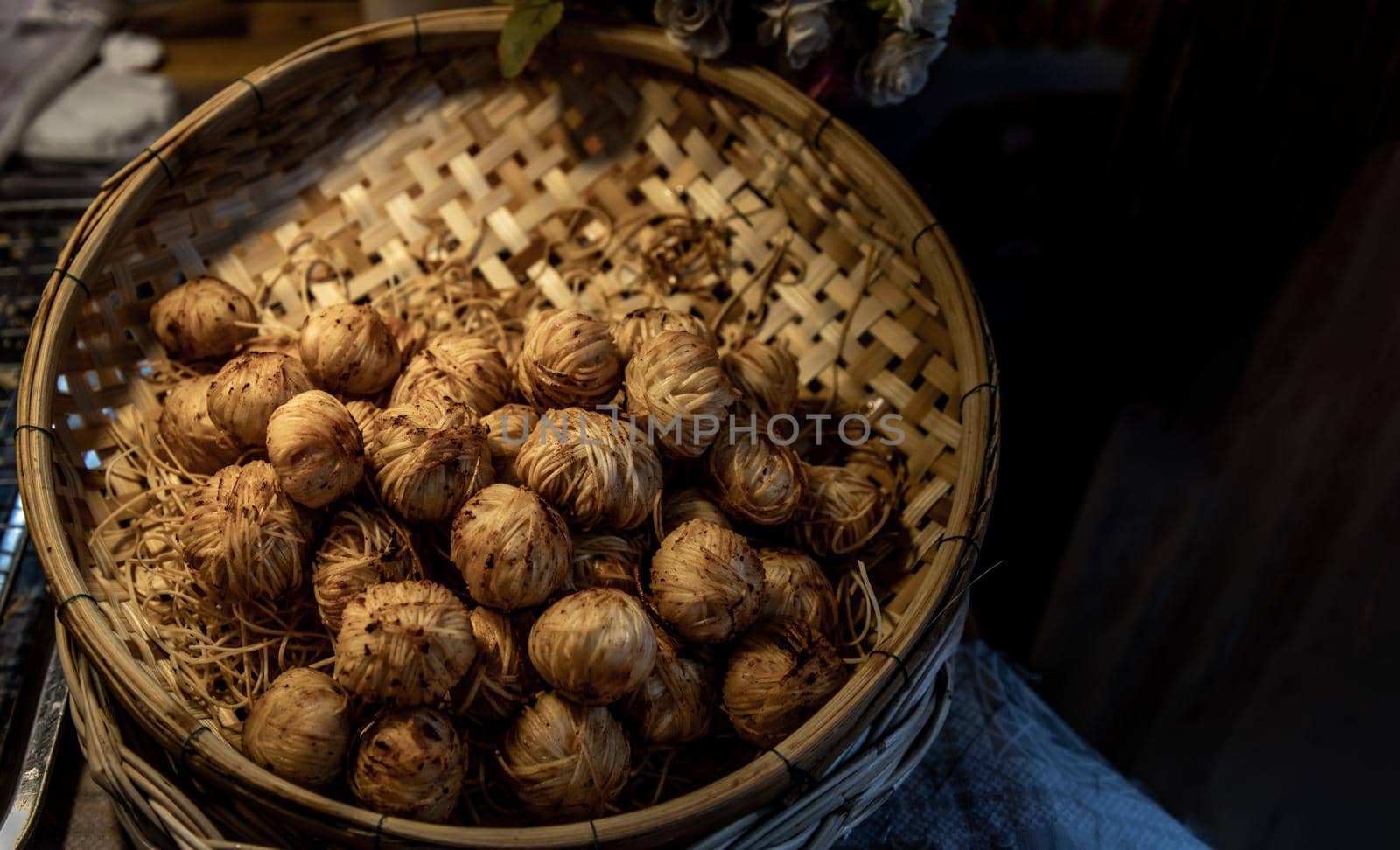 Deep Fried Wrapped Pork with Chinese Noodle or Fried pork ball with noodle or Moo Sarong serving on a Bamboo basket hand made, Authentic recipes, classical Thai cuisine.