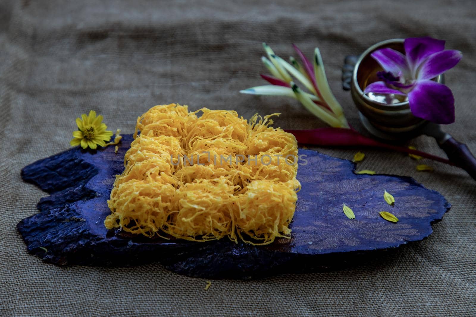 Traditional Thai desserts sweet and delicious : Golden egg strip is Thai desserts made from eggs on wooden background ( Thai name is Foi Thong).