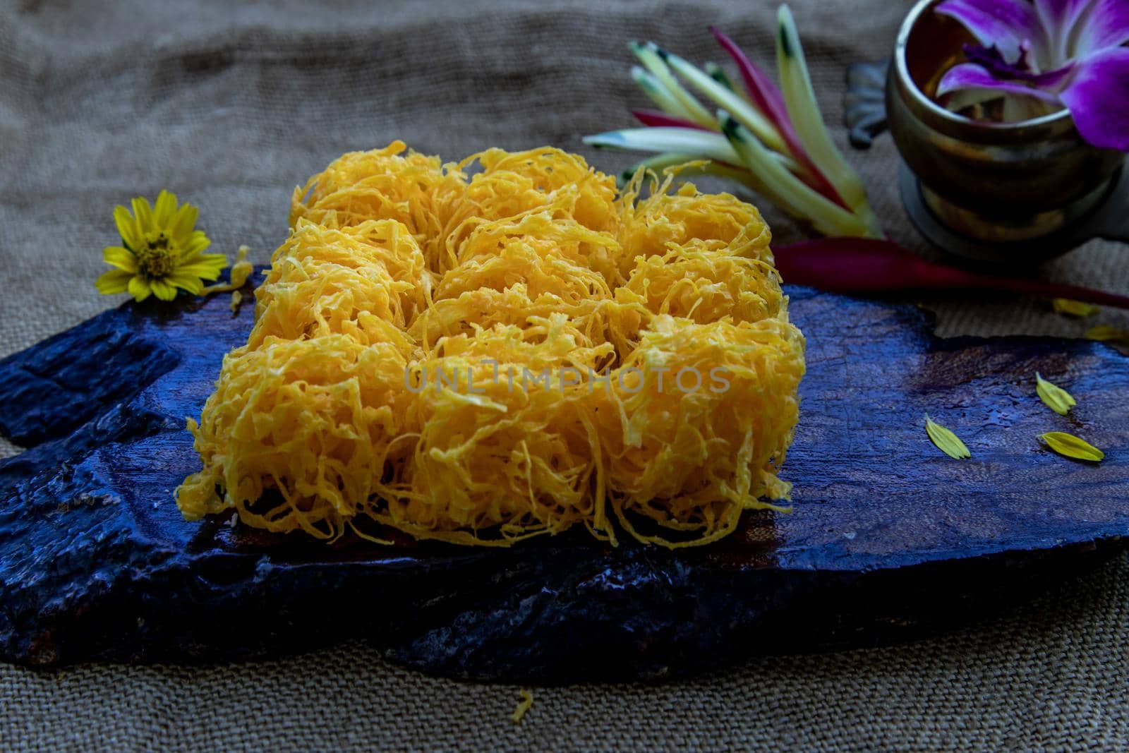 Traditional Thai desserts sweet and delicious : Golden egg strip is Thai desserts made from eggs on wooden background ( Thai name is Foi Thong).