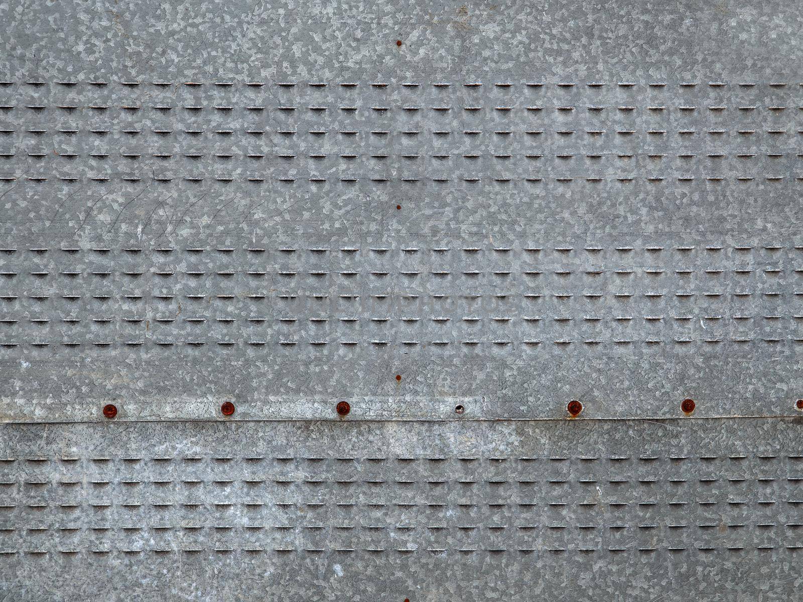 Grey metal sheets are fastened with screws.