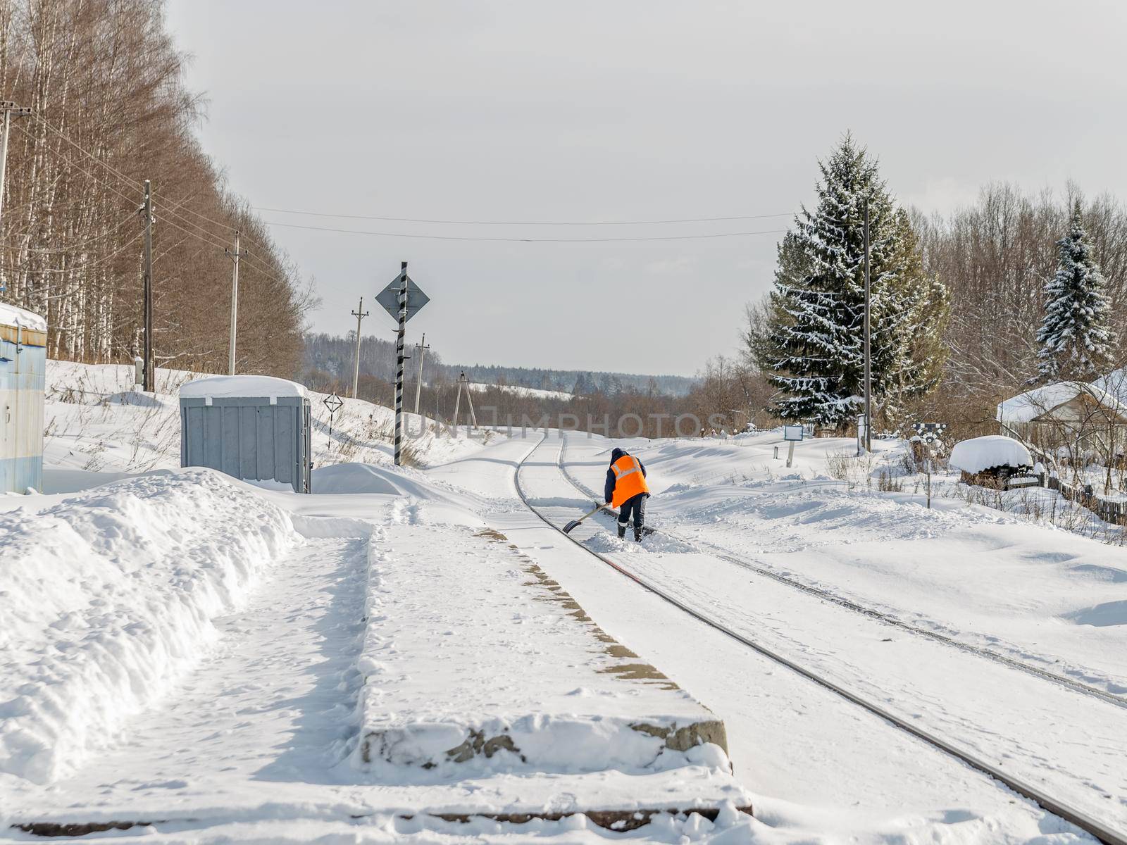 Railroad tracks and platform clears of snow.