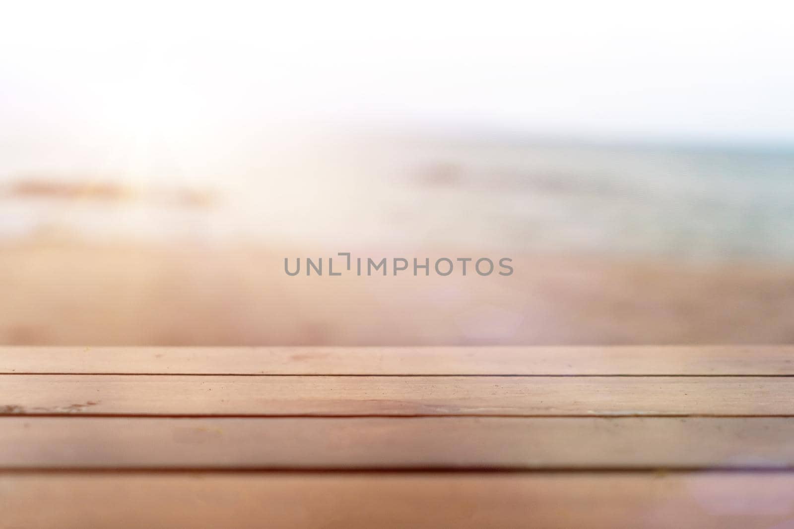 Selective focus of old wood table with blur beautiful beach background for display your product.