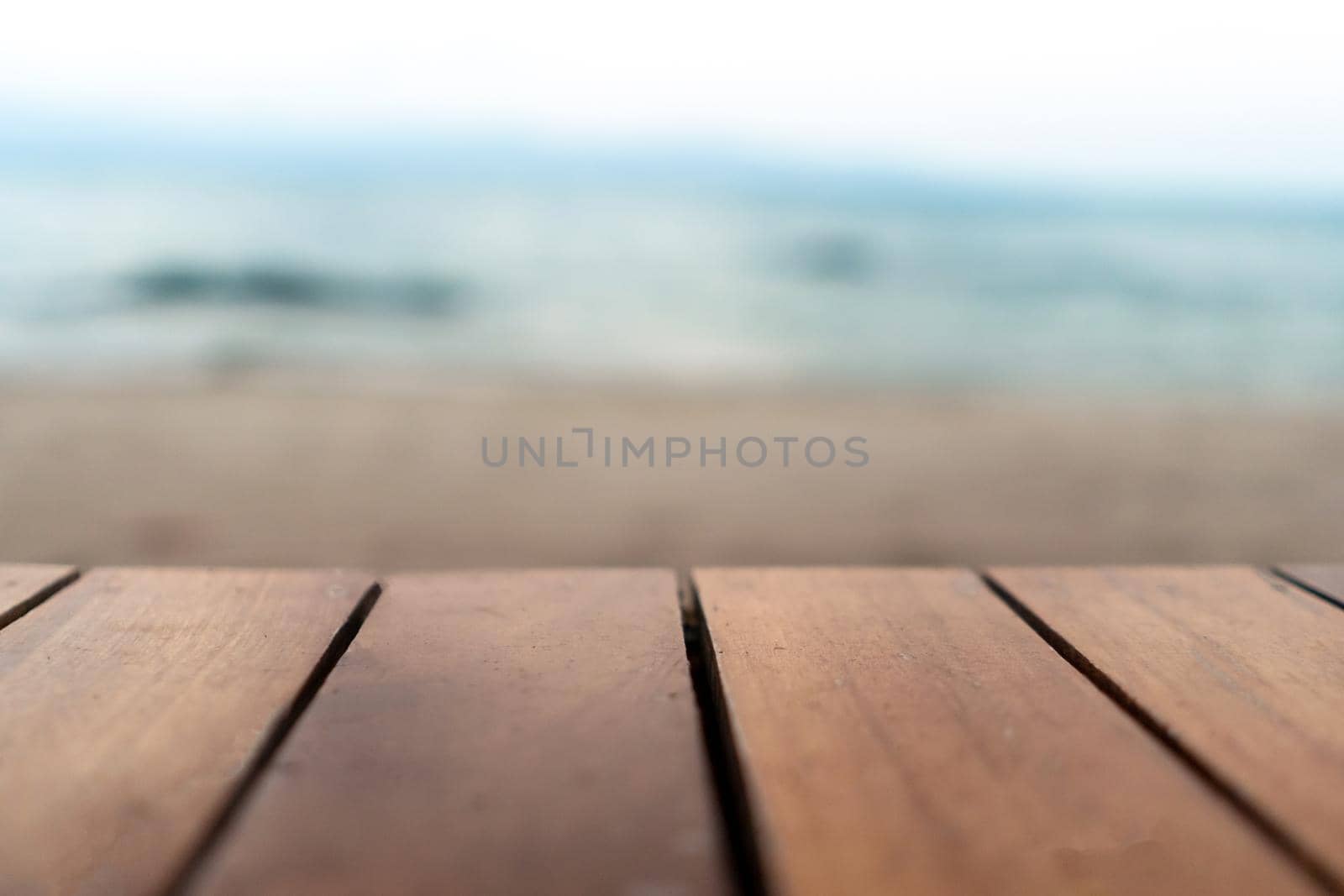 Selective focus of old wood table with blur beautiful beach background for display. by Suwant