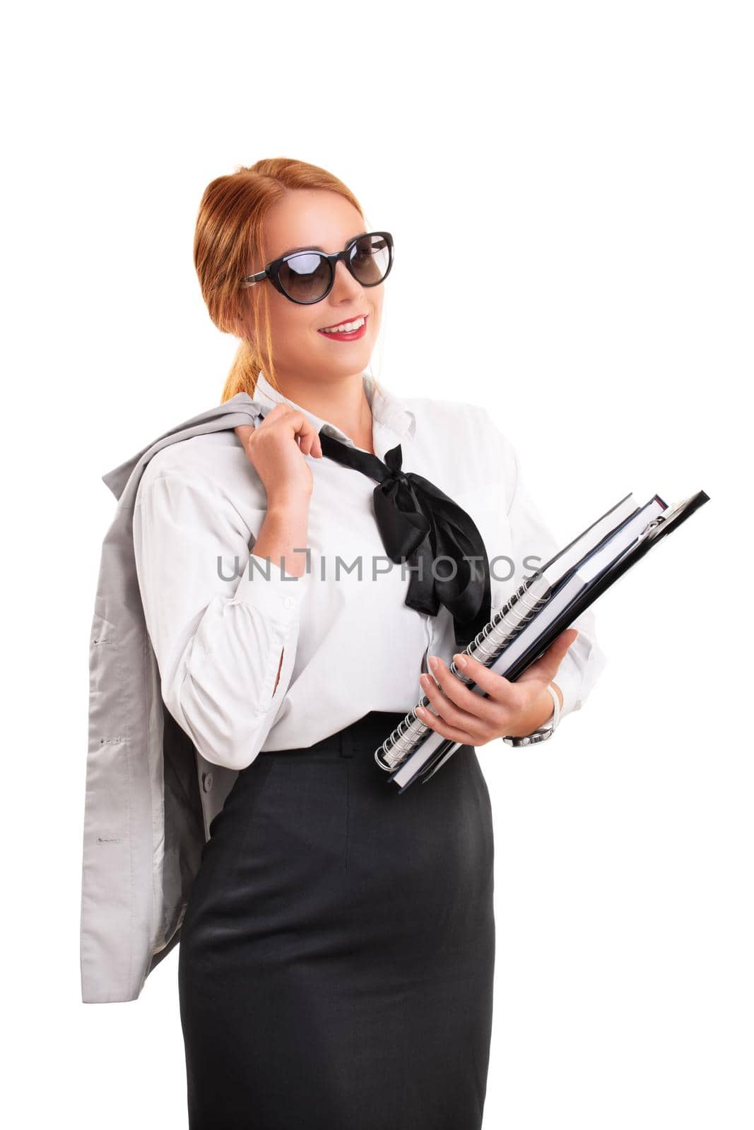 Young fashionable businesswoman holding notebooks and clipboard by Mendelex