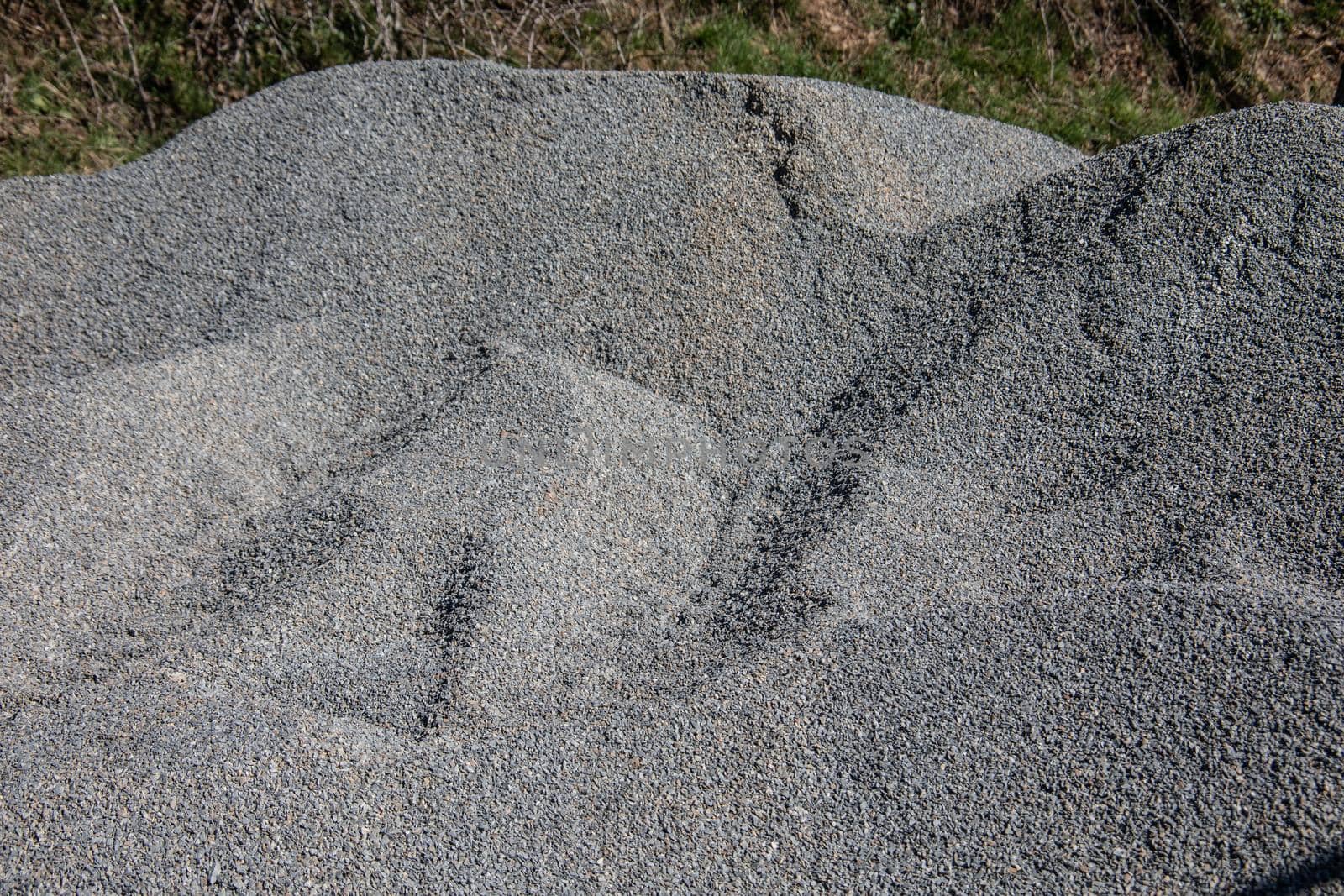 Pile of gravel at the roadside for road construction