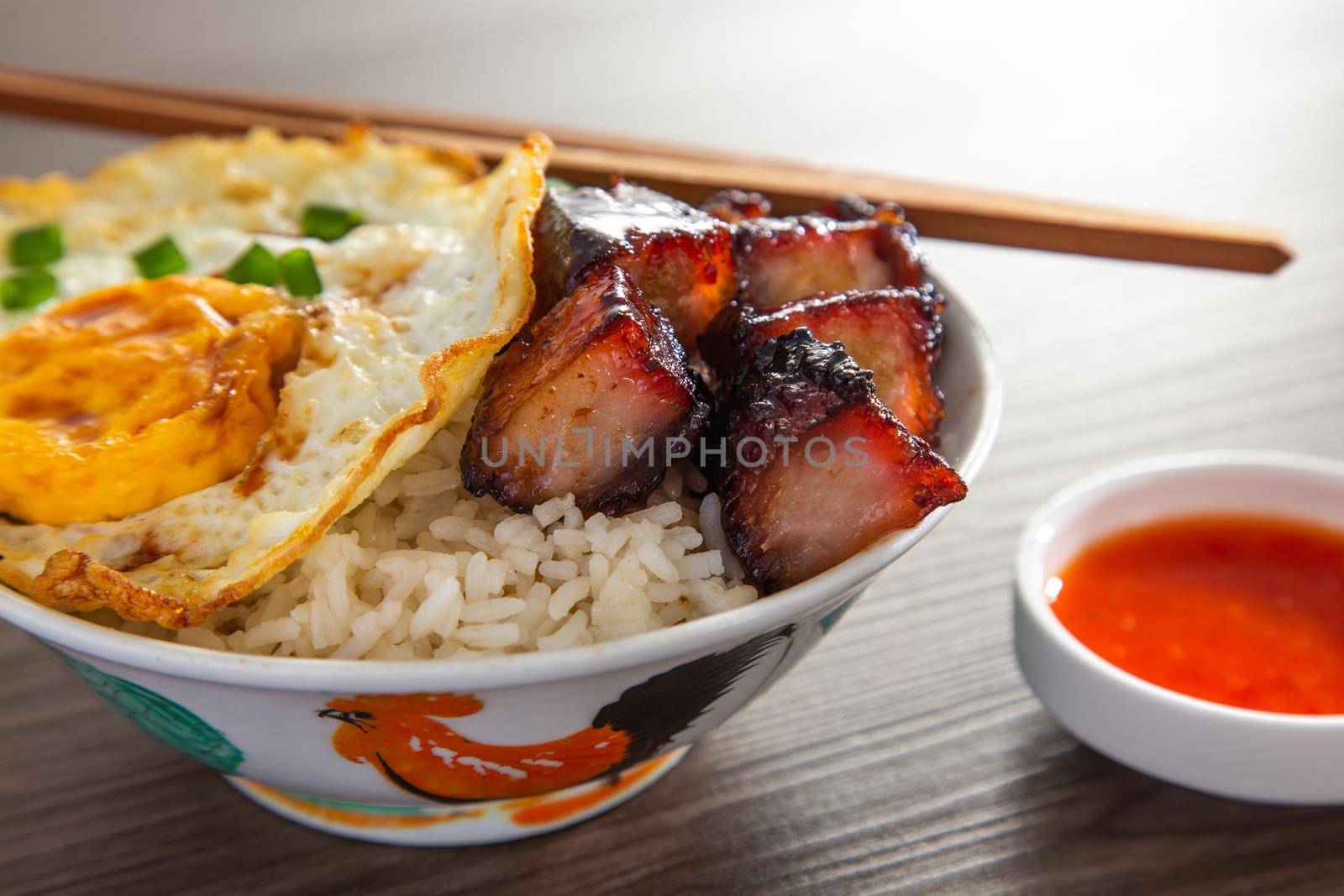 Chinese Sweet Bbq Pork is marinated in a sweet BBQ sauce and served with white rice. by tehcheesiong
