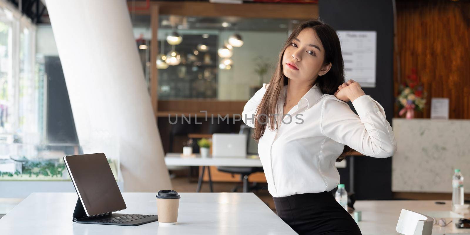 Portrait of business female having rest while situating at table in apartment. Job and leisure concept