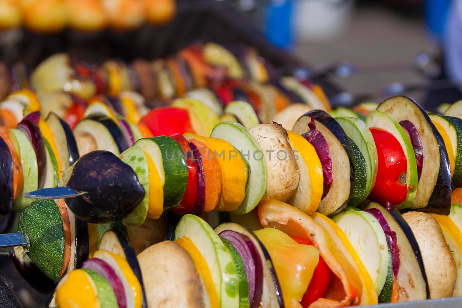 Vegetarian kebab from vegetables. On skewers zucchini, peppers, mushrooms.