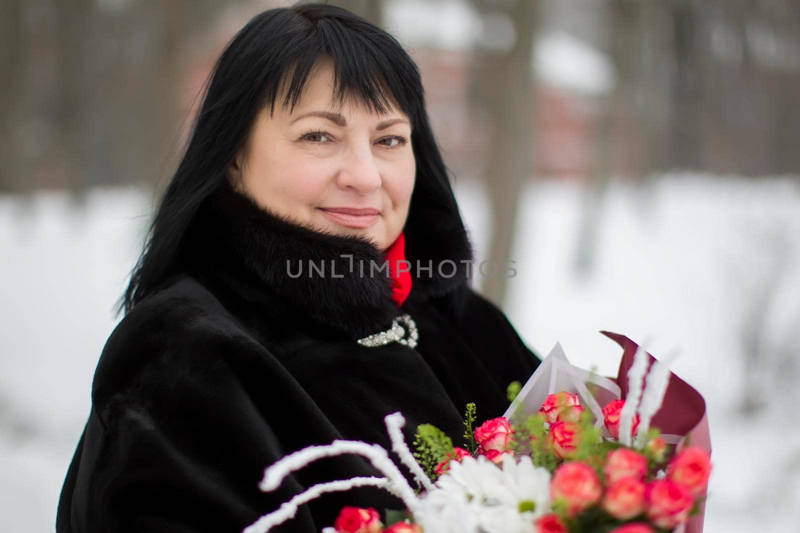Beautiful elderly woman with a bouquet of flowers