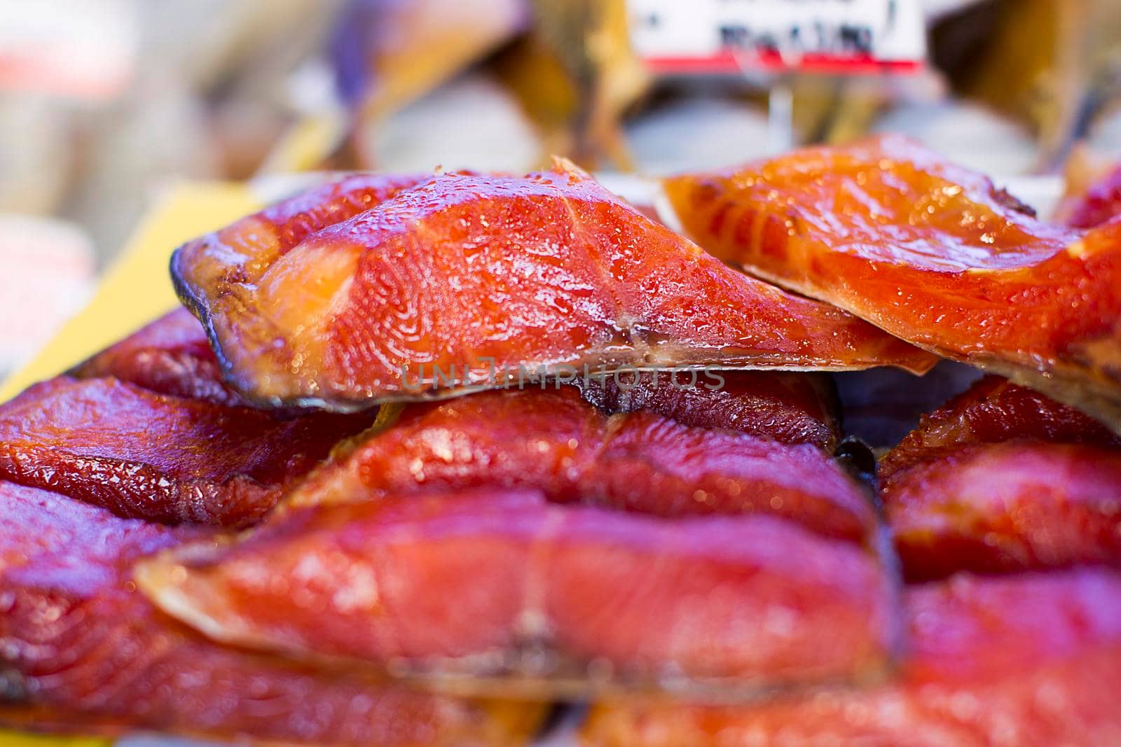 Chunks of red smoked fish.Dried fish at the fish market