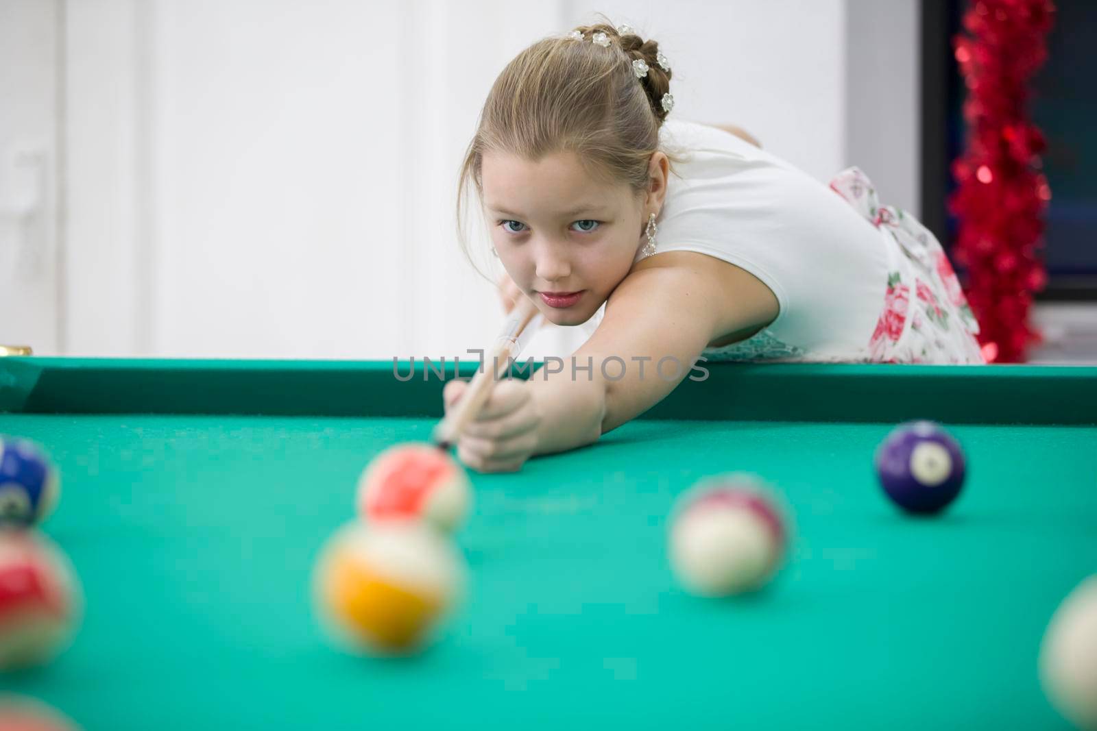 Girl playing billiards. Daughter playing pool by Sviatlana