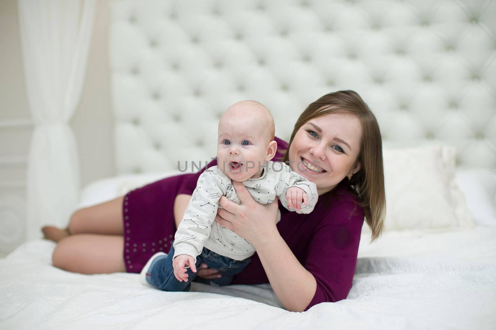 Mom with her little son on the bed.Mother and baby