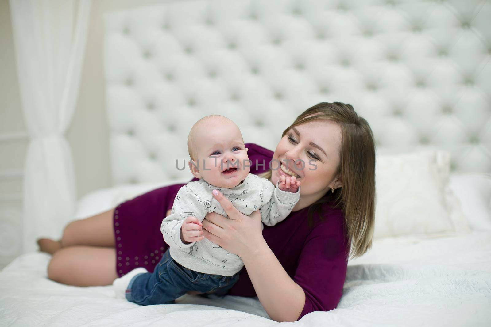 Mom with her little son on the bed.Mother and baby