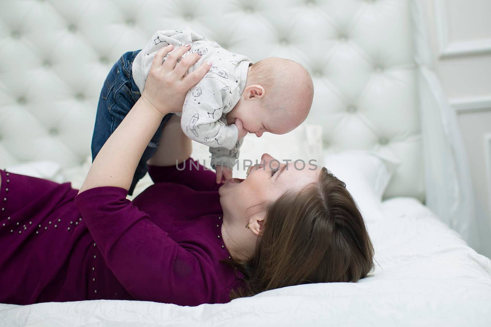 Mom with her little son on the bed.Mother and baby