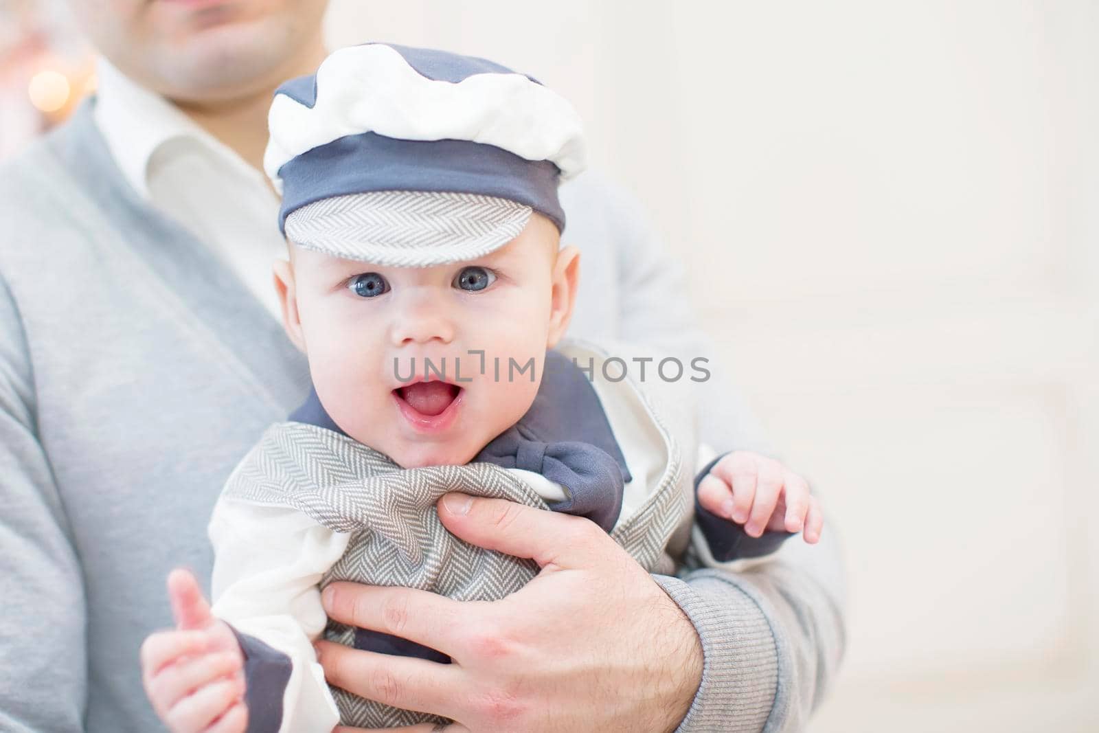 Cheerful playful baby in his father's arms. Baby and dad by Sviatlana