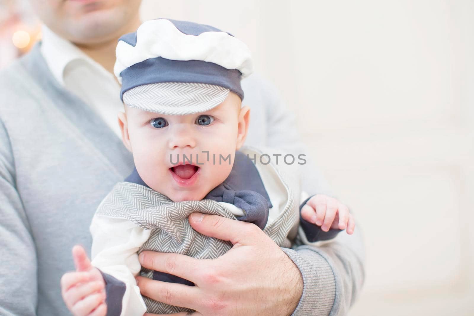 Cheerful playful baby in his father's arms. Baby and dad