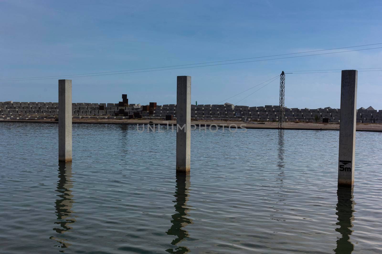 Saltwater pool in the Mediterranean Sea, in winter, without waves and a cloudy blue sky. November in Barcelona Spain.