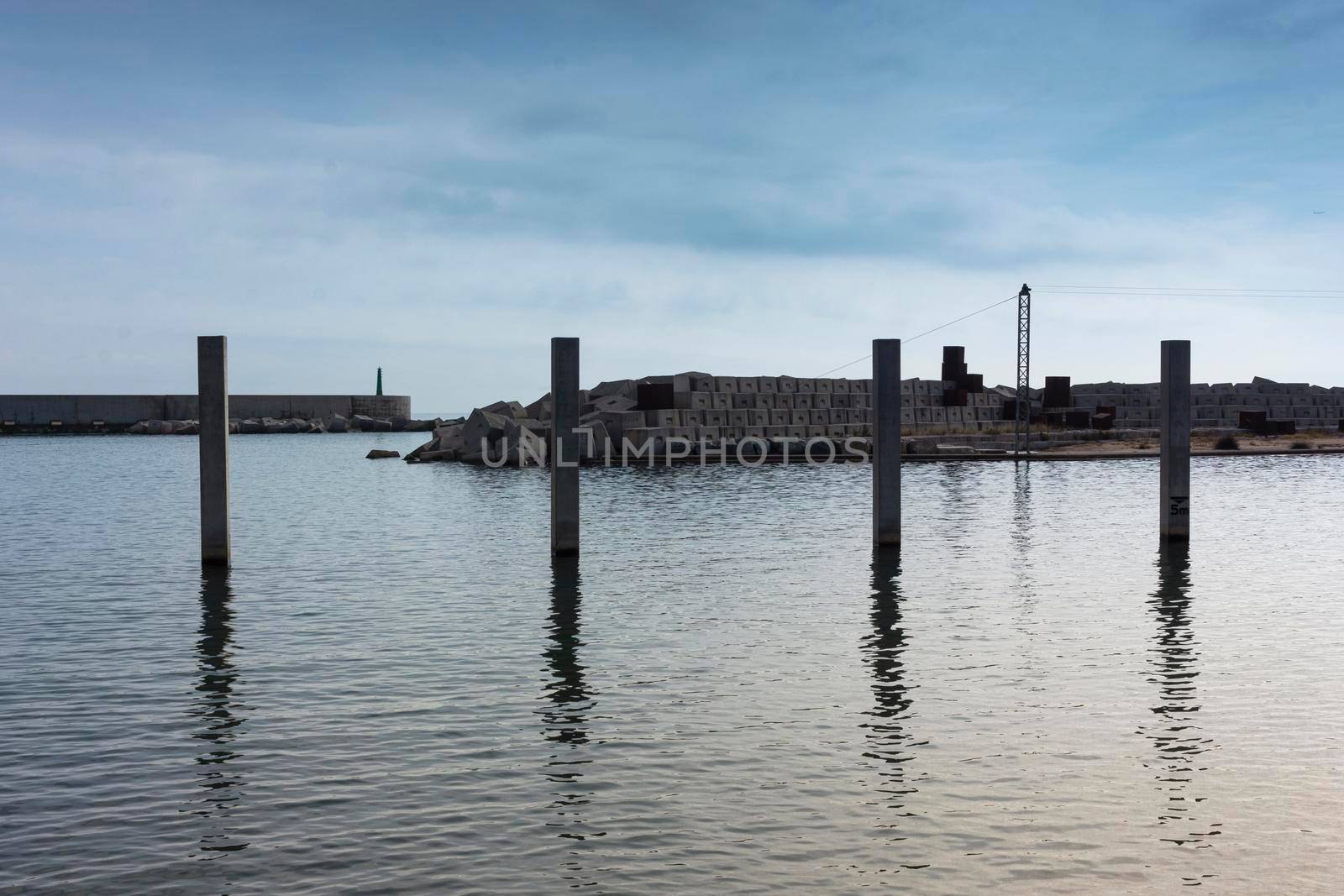 Saltwater pool in the Mediterranean Sea, in winter, without waves and a cloudy blue sky. November in Barcelona Spain.