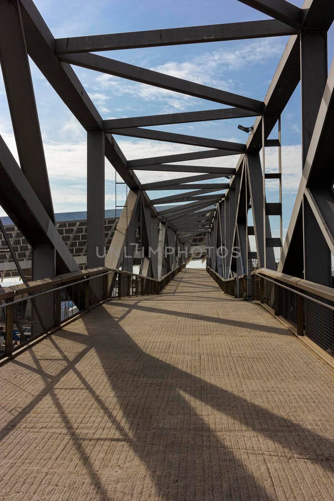 Metal bridge on a jetty in the coastal area in Barcelona by loopneo