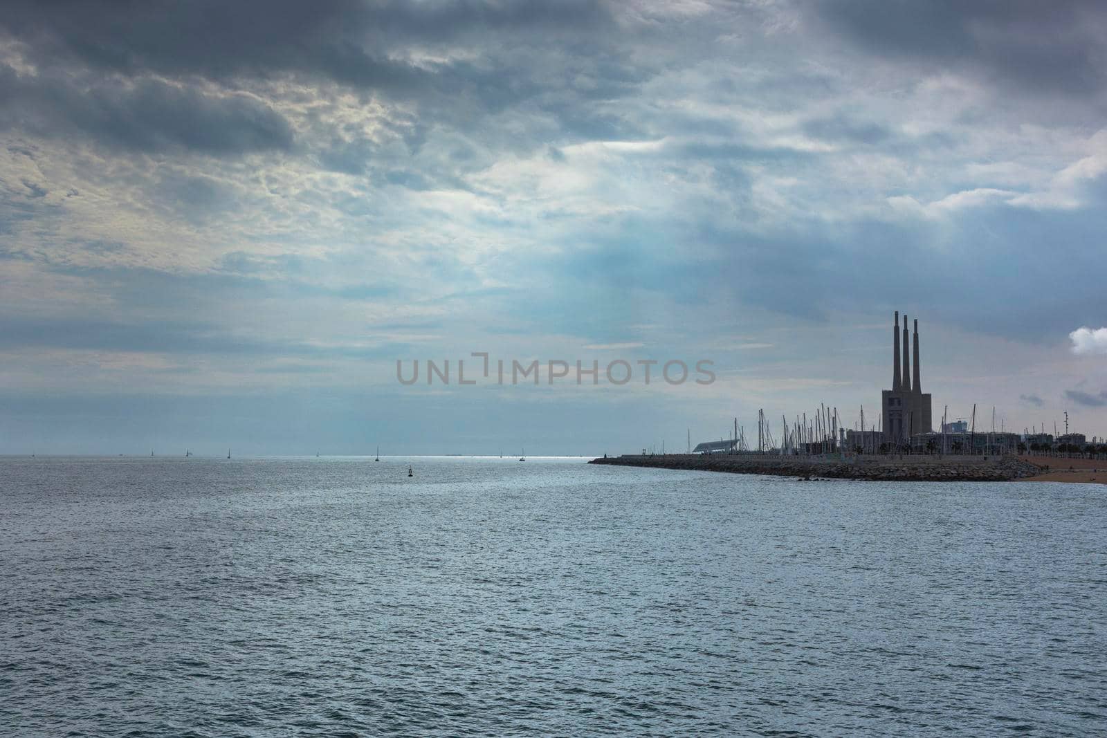 Seascape in the Mediterranean Sea with views of an old disused Thermal Power Plant for the production of electricity by loopneo