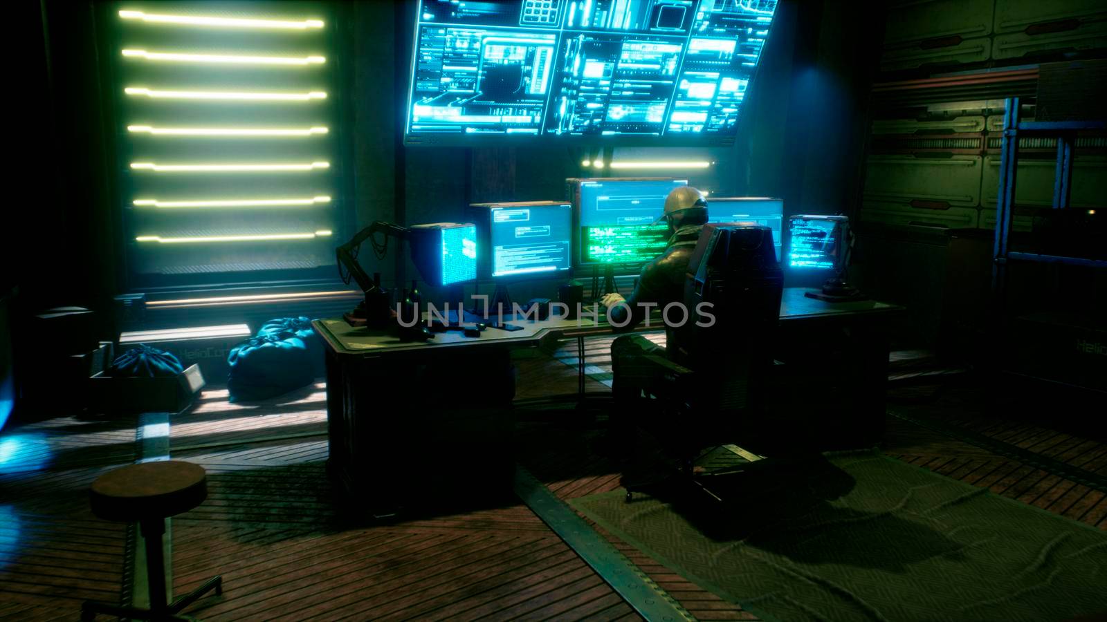 A male hacker surrounded by glowing monitors hacks into someone else's computer network in a dark room of his office. A view of the hacker's futuristic computer office.