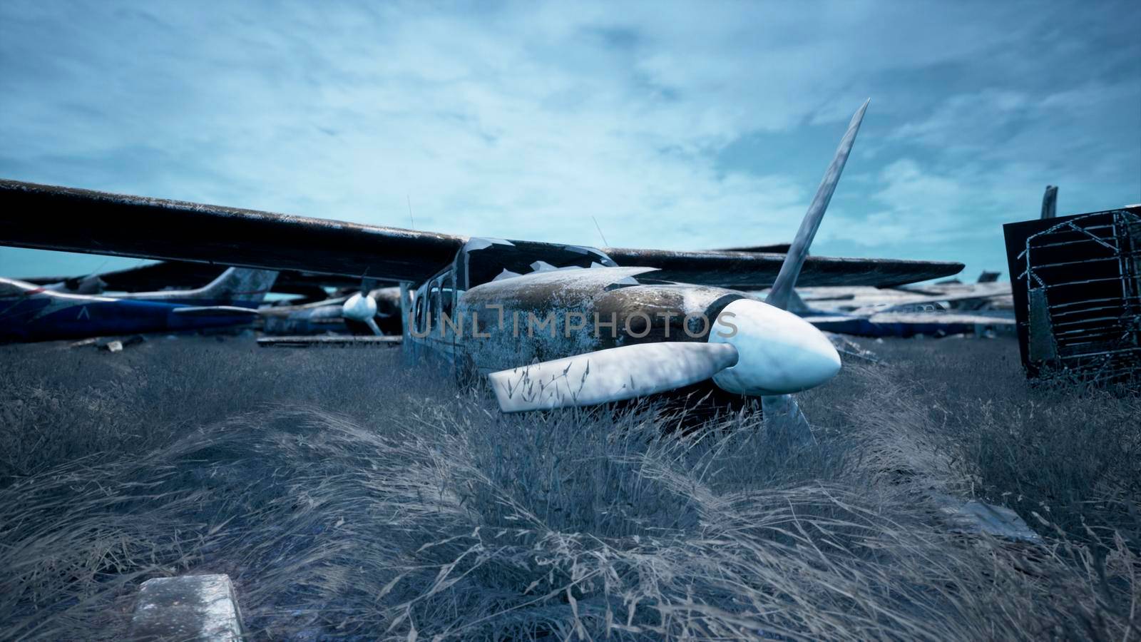 Abandoned and destroyed planes are in the field. A lot of rusty, forgotten and broken planes.