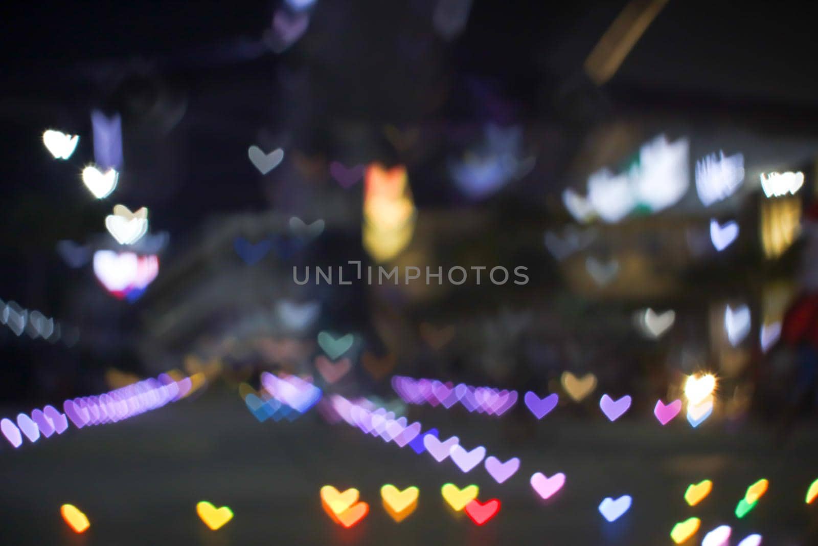 rainbow bokeh and blur heart shape love valentine colorful night light on floor