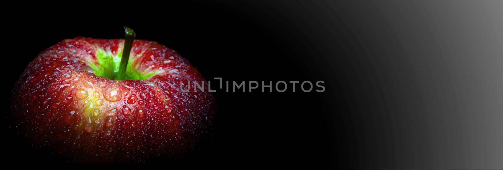 Close-up of Water droplet on glossy surface of freshness red apple on black background