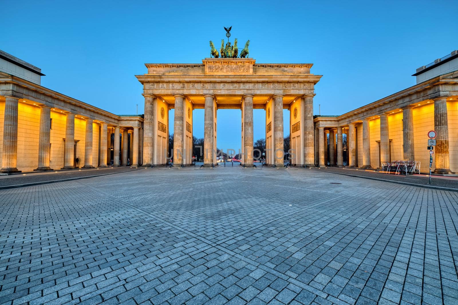 The illuminated Brandenburg Gate in Berlin at dawn