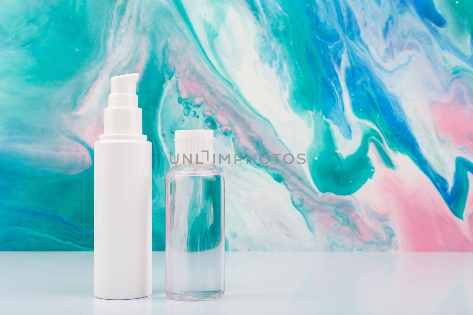 Face cream and lotion on white table against blue marbled background with copy space. by Senorina_Irina