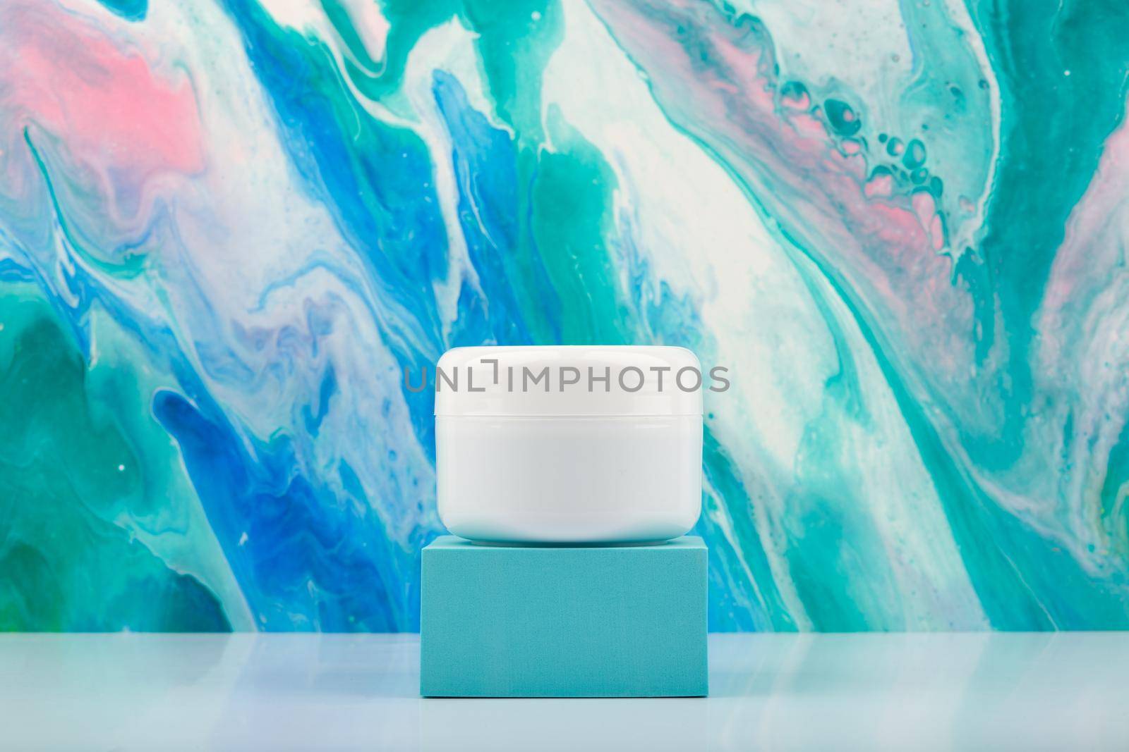 White cosmetic jar on blue podium against marbled background in blue colors with copy space by Senorina_Irina
