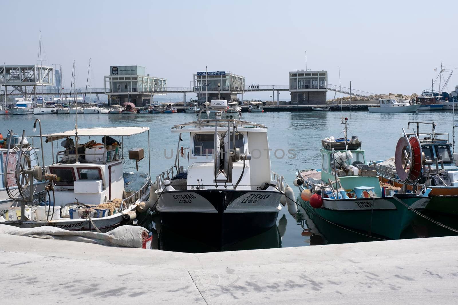 Large sailing boats and yachts on the pier on a clear Sunny day.