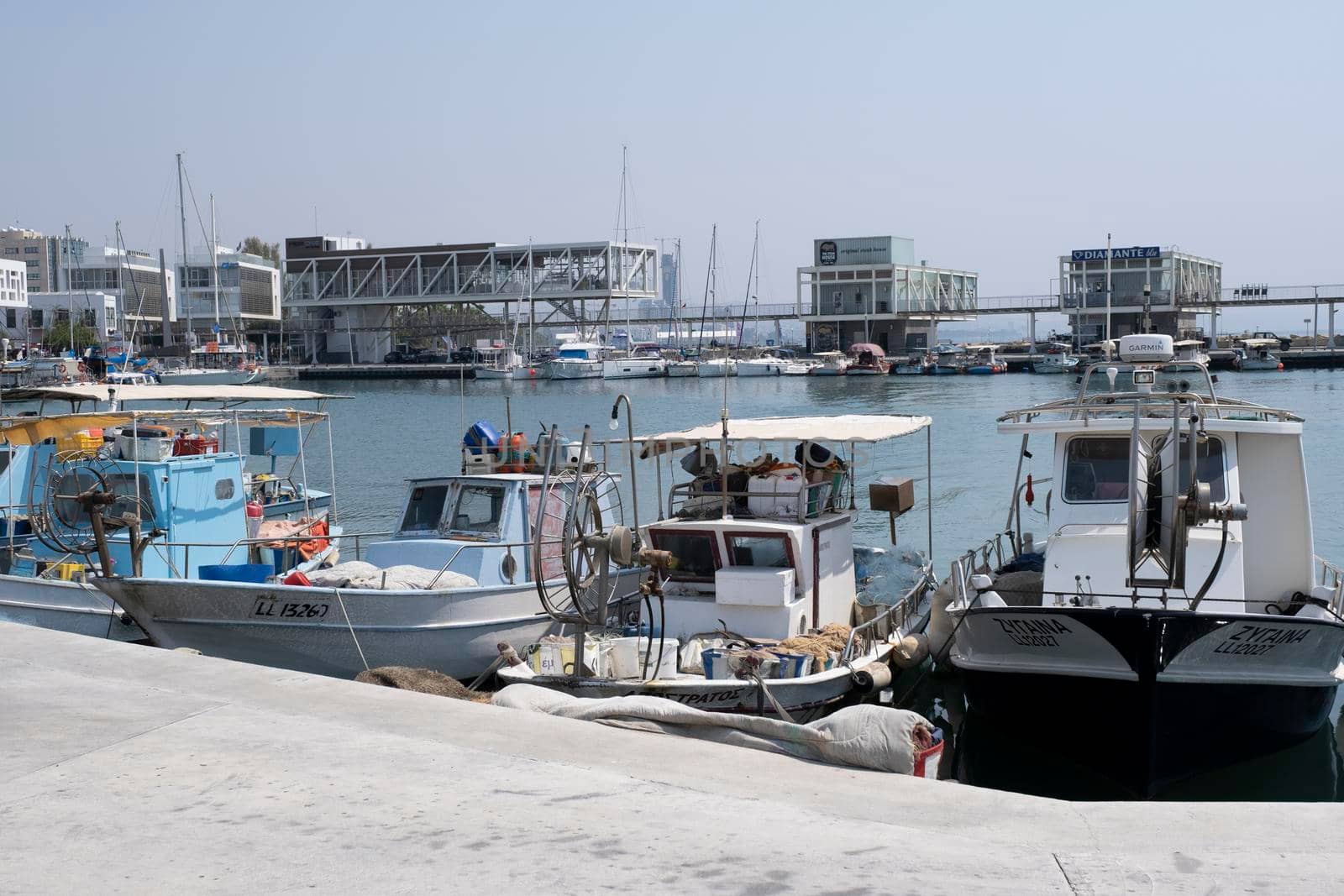 Large sailing boats and yachts on the pier on a clear Sunny day.