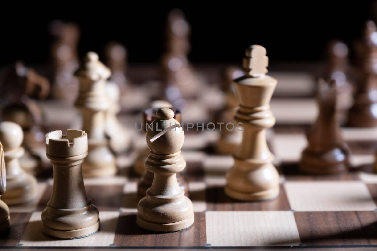 Chess game. White and black pieces are fighting for victory. The Central figure is in focus. The concept of teamwork.