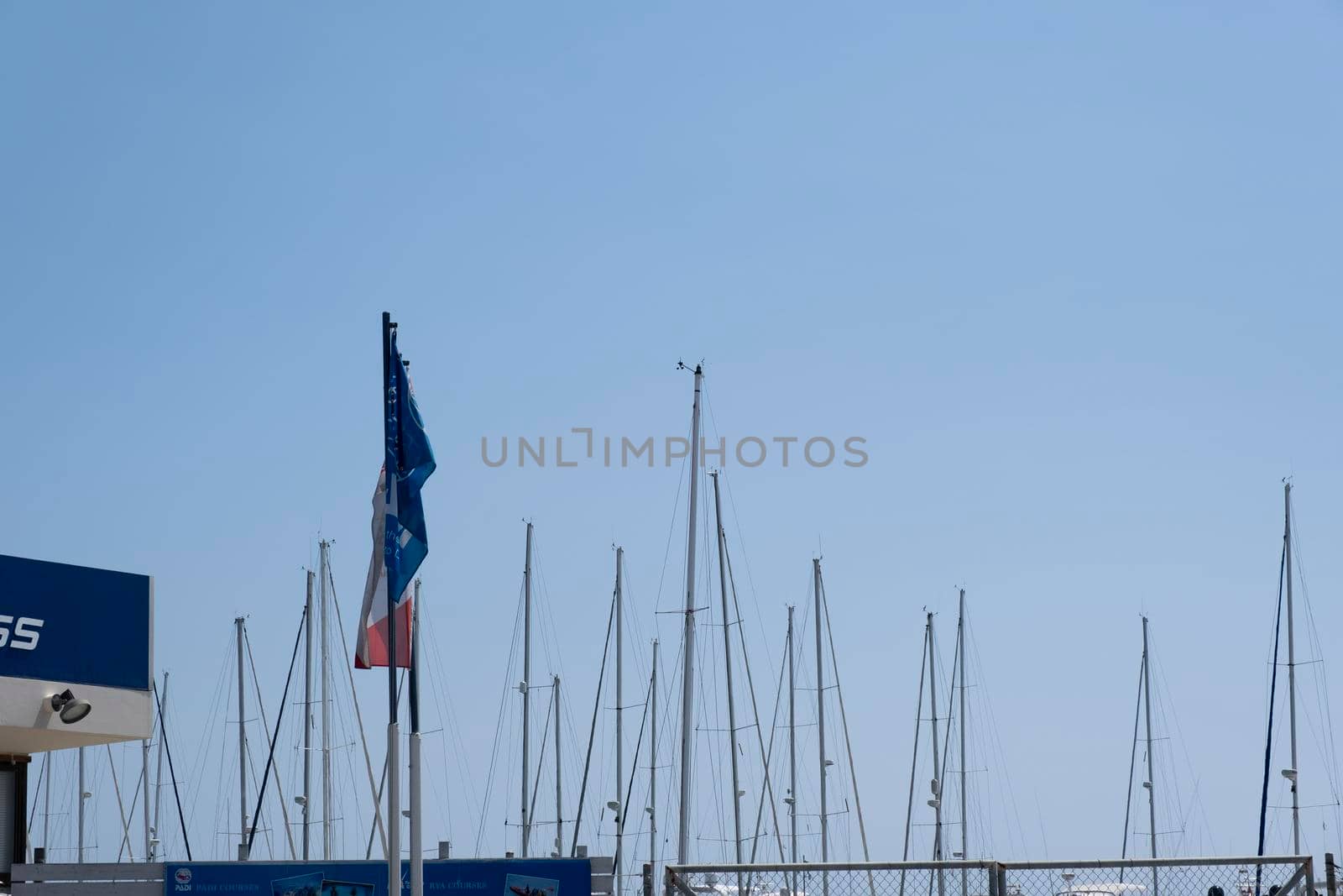 Large sailing boats and yachts on the pier on a clear Sunny day.