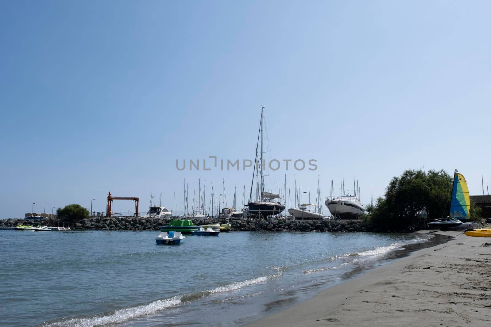 Large sailing boats and yachts on the pier on a clear Sunny day.