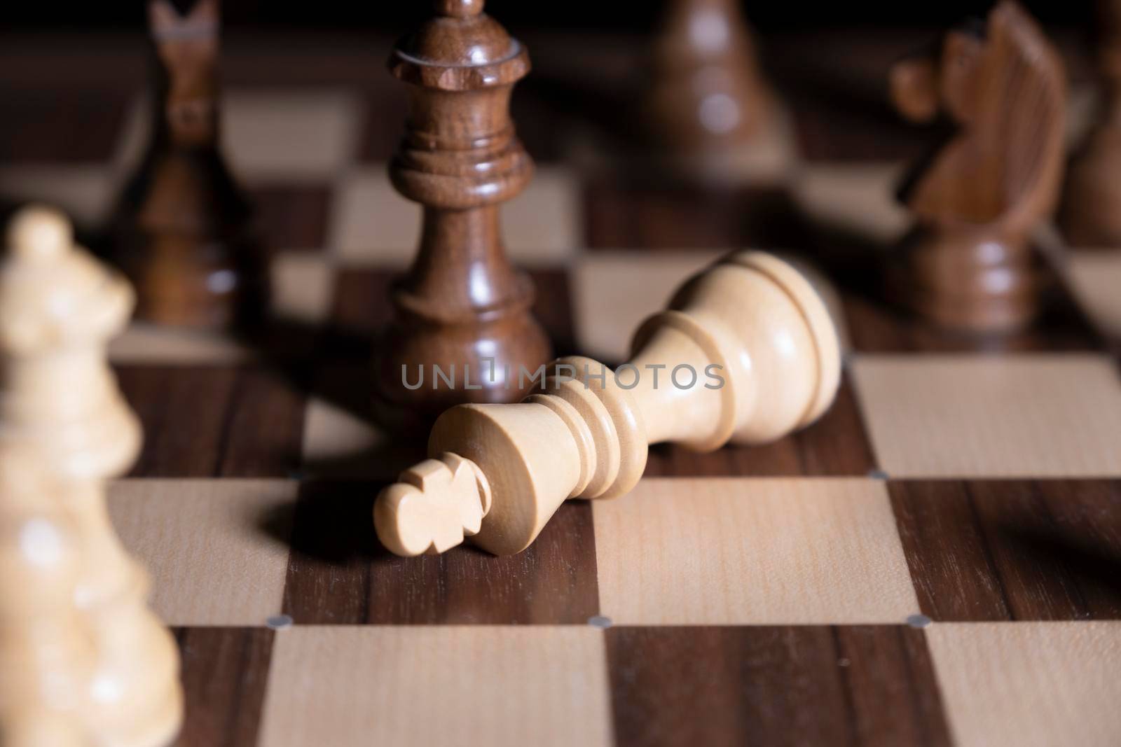 Chess game. White and black pieces are fighting for victory. The Central figure is in focus. by designprojects