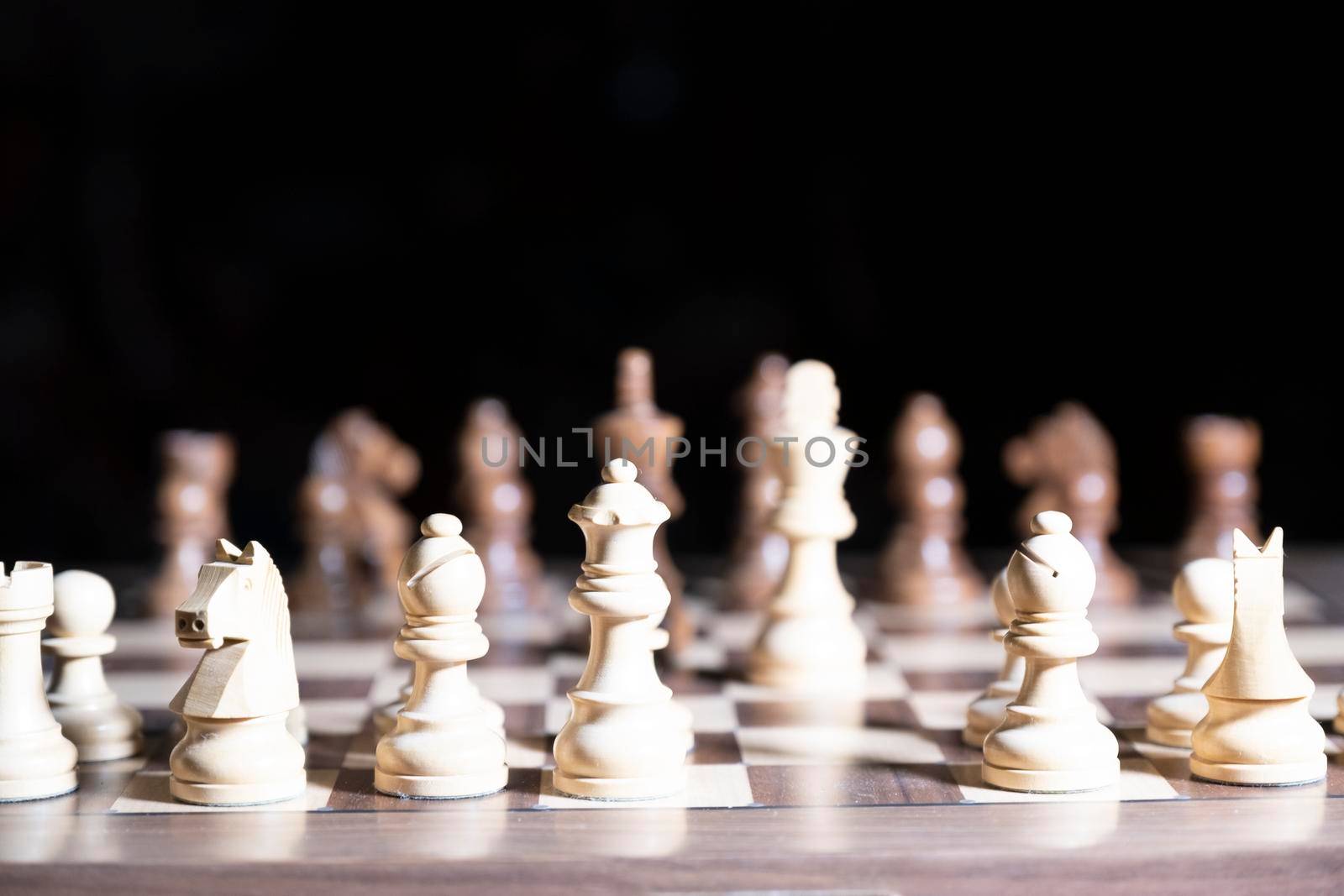 Chess game. White and black pieces are fighting for victory. The Central figure is in focus. The concept of teamwork.