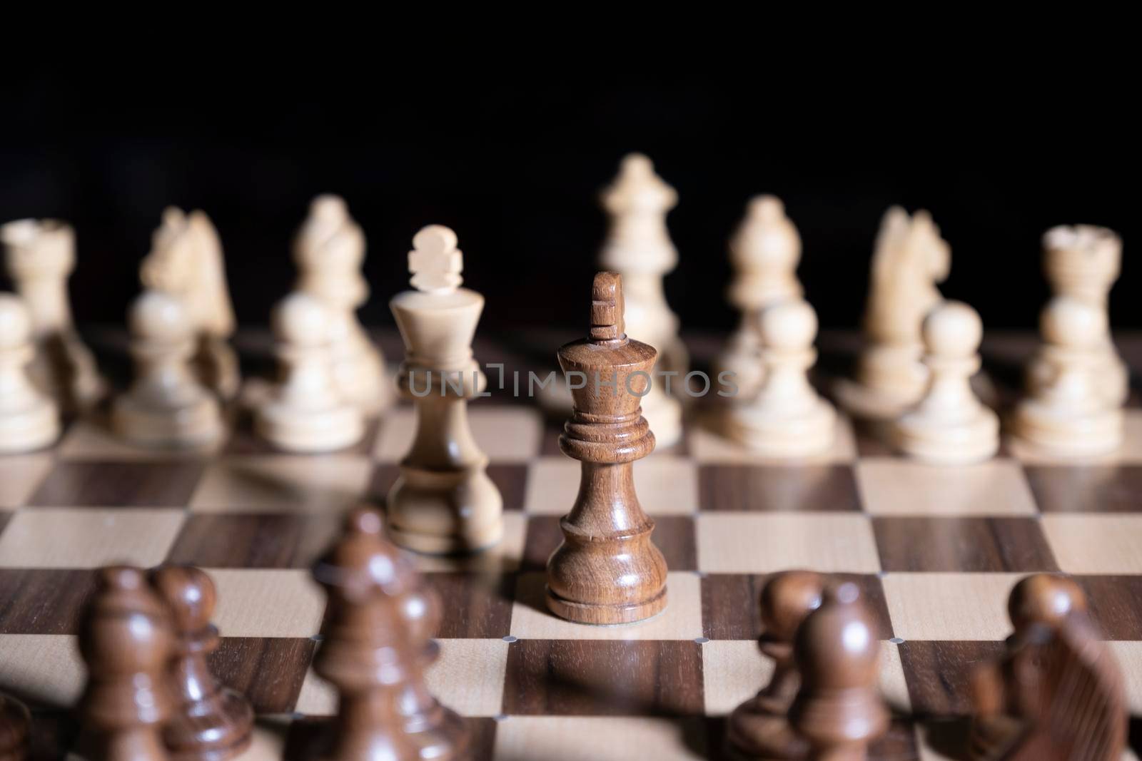 Chess game. White and black pieces are fighting for victory. The Central figure is in focus. by designprojects